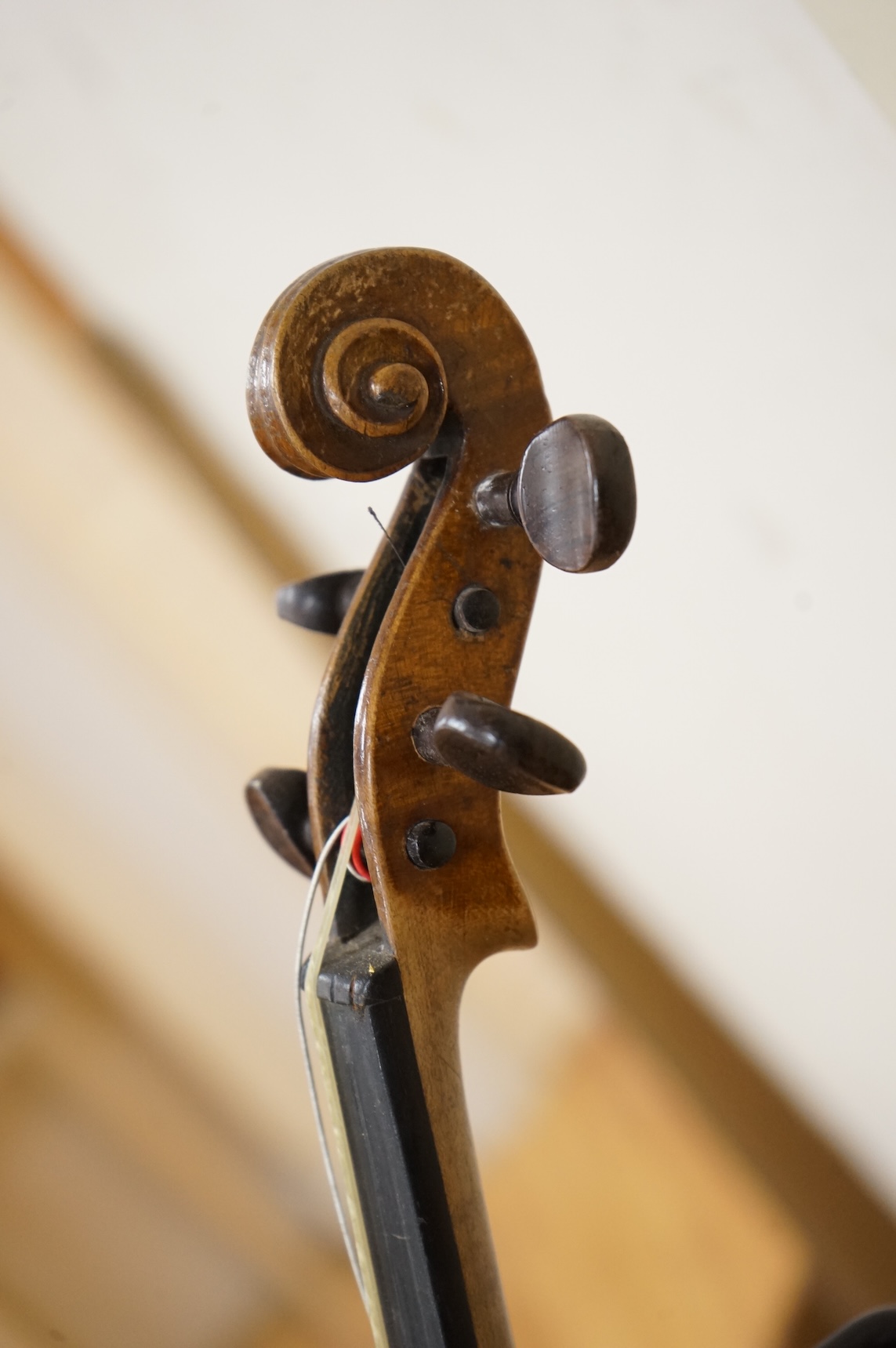 Five cased 20th century violins, including; a German violin, two Czech violins, a three-quarter size violin with a label for Bienfait, and a Romanian quarter size violin, all in cases or the remains of cases.